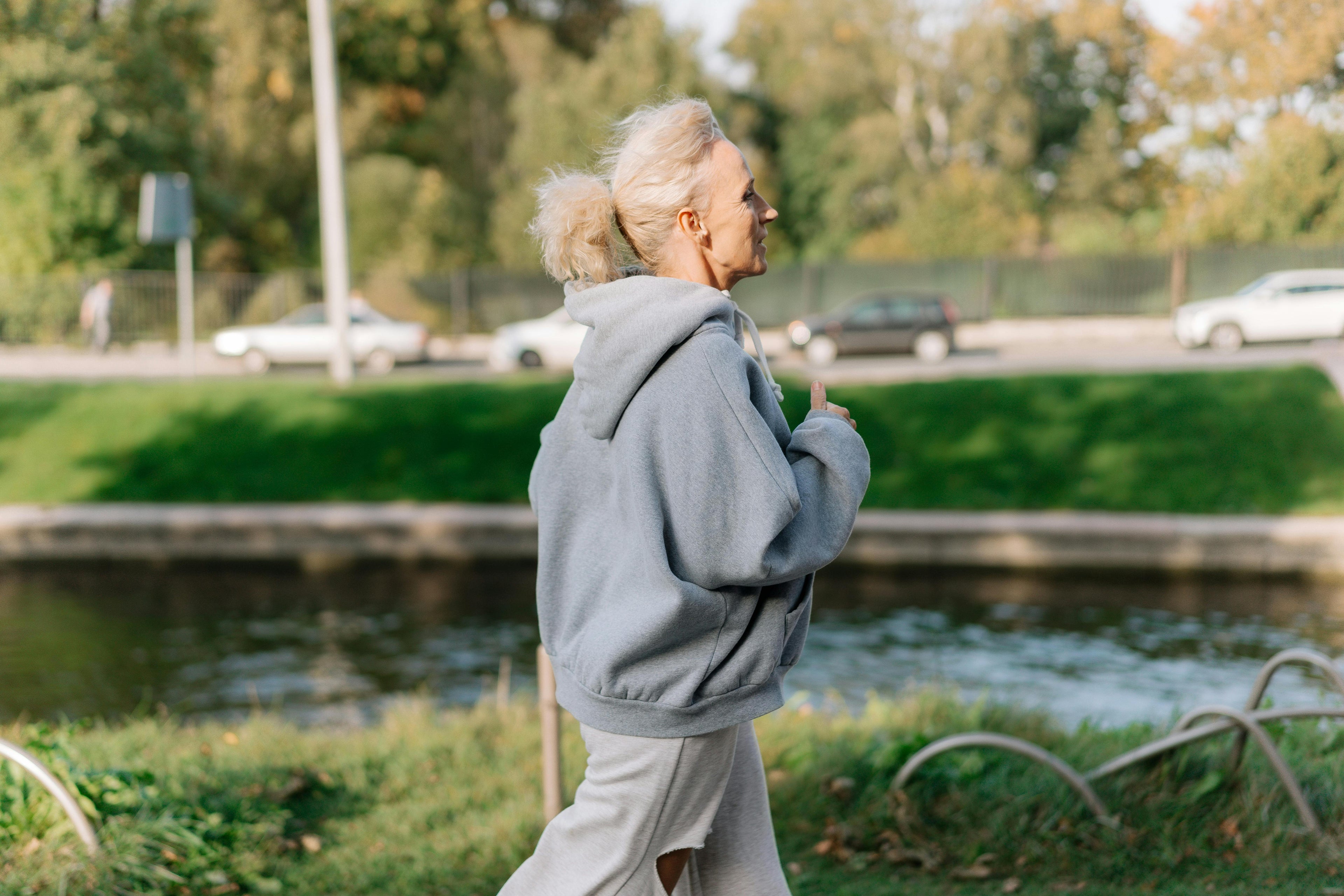 Active older woman jogging outdoors in a park — Standard Screen Plus comprehensive health blood test including thyroid and tumour markers