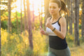 Woman jogging in a sunny forest with earphones — Advanced GP3 comprehensive blood test including hormonal, allergy and digestive health markers