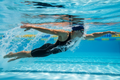 Competitive swimmer racing underwater in a pool — Sports Performance blood test for athletes covering hormonal, metabolic and nutritional markers
